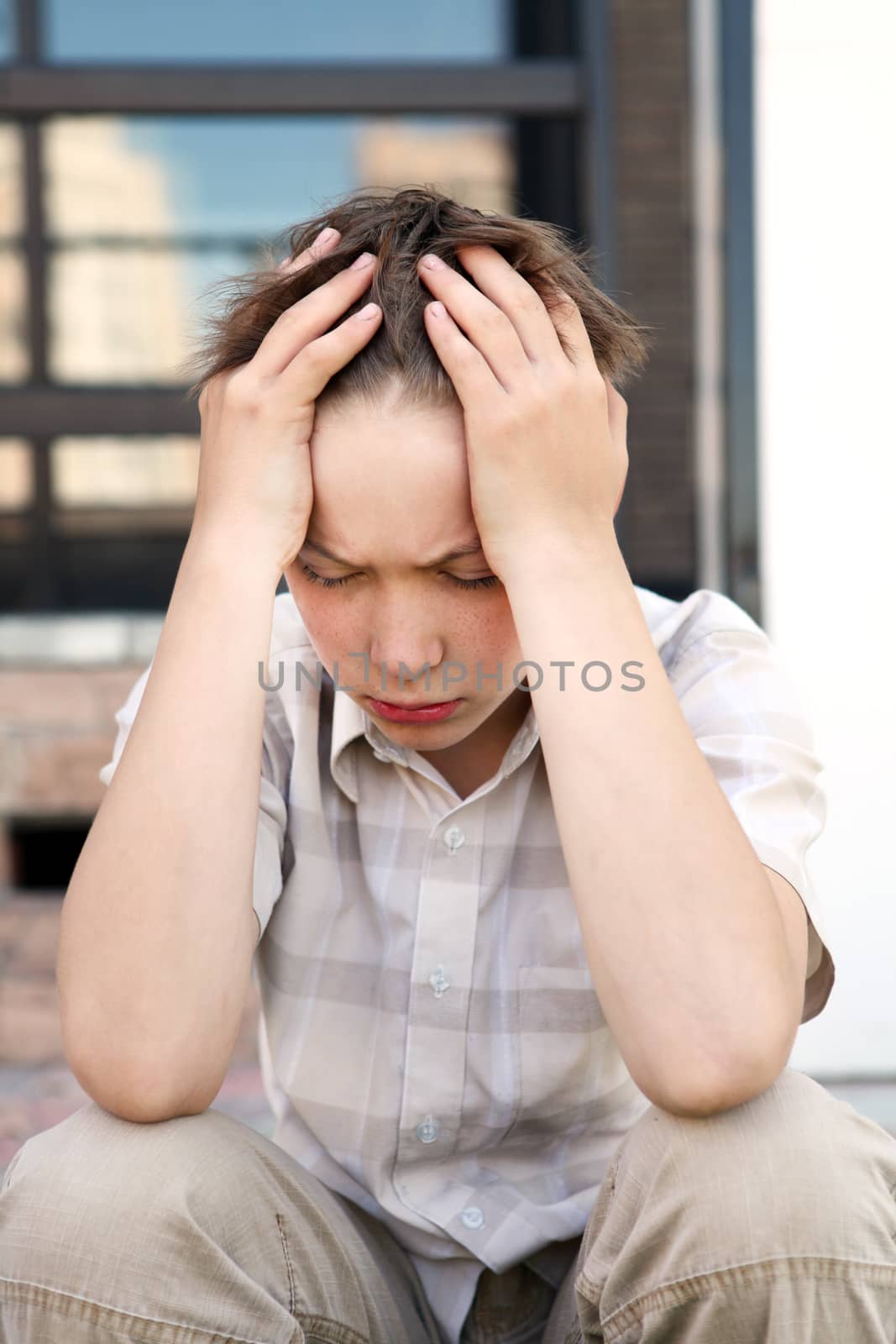 Sad and Troubled Kid sitting outdoor