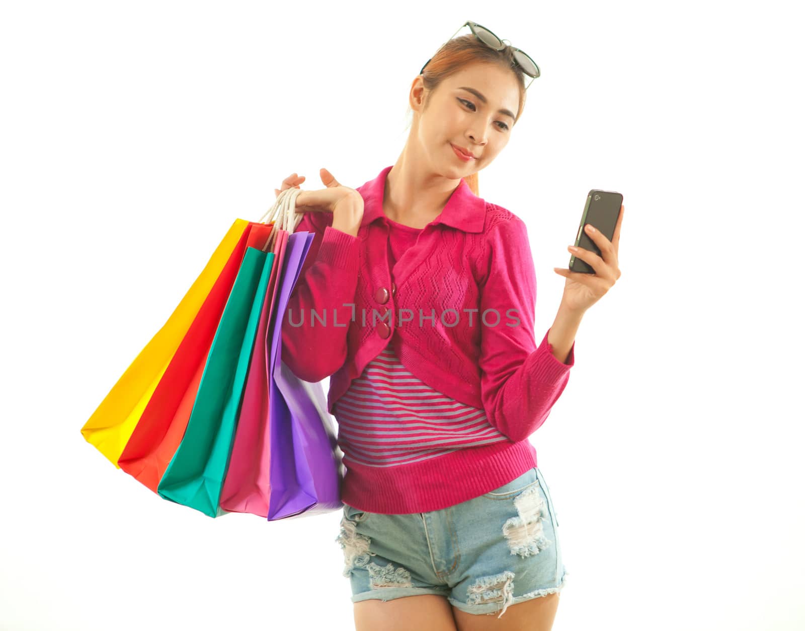 Shopping young asian woman talking on the phone looking happy isolated on white background