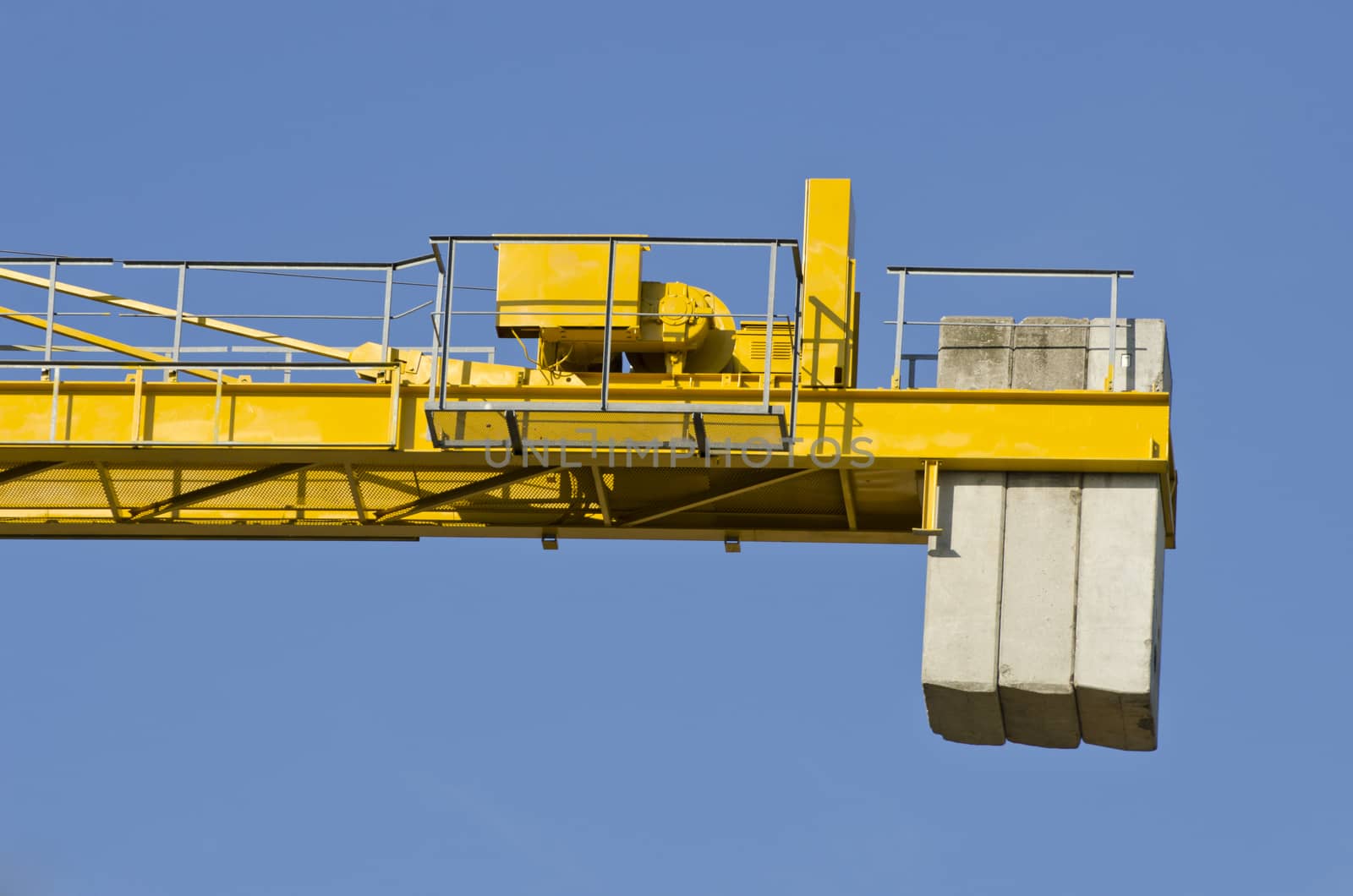 steel crane construction fragment with concrete weight