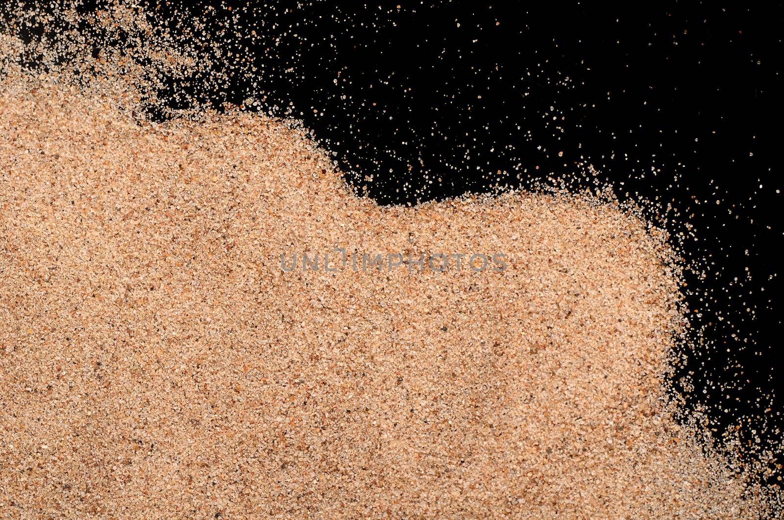 The sand on the black background close-up