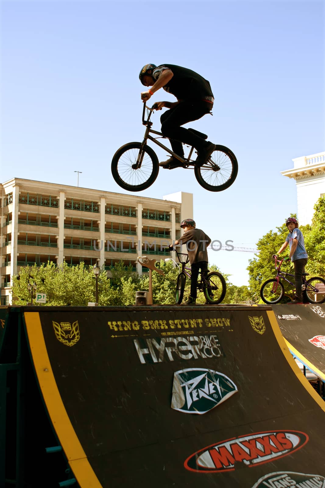 Athens, GA, USA - April 26, 2014:  A young man practices his park jumping tricks before the start of the BMX Trans Jam competition on the streets of downtown Athens.