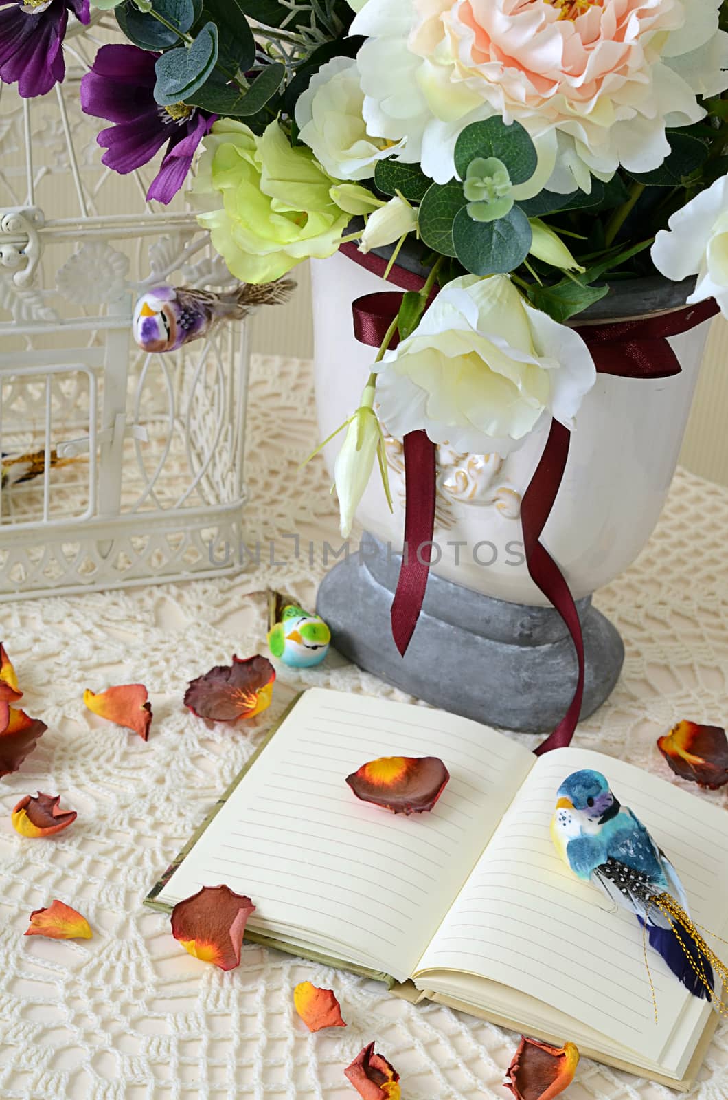 The book on a table with rose-petals