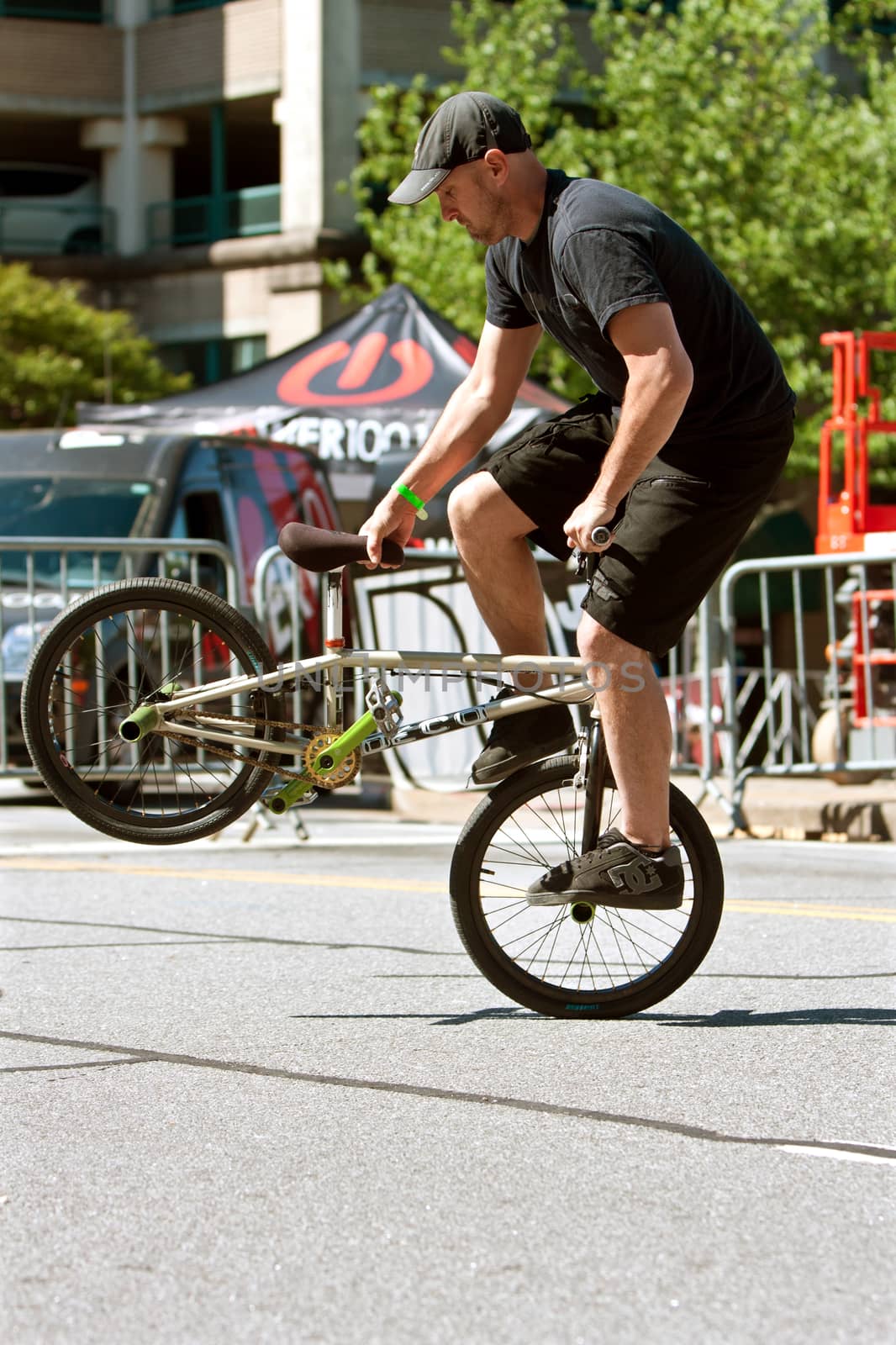 Athens, GA, USA - April 26, 2014:  A man practices his flatland tricks before the start of the BMX Trans Jam competition on the streets of downtown Athens.