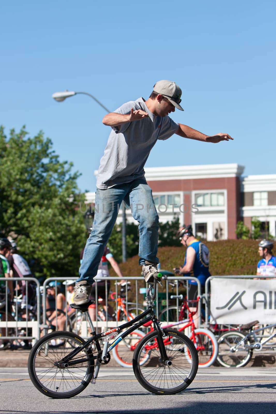Athens, GA, USA - April 26, 2014:  A young man practices his flatland tricks before the start of the BMX Trans Jam competition on the streets of downtown Athens.