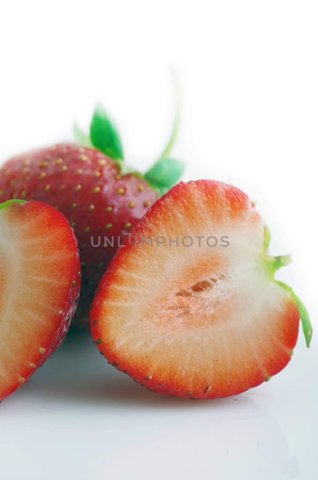 Healthy red strawberry fruit sliced isolated on the white background 