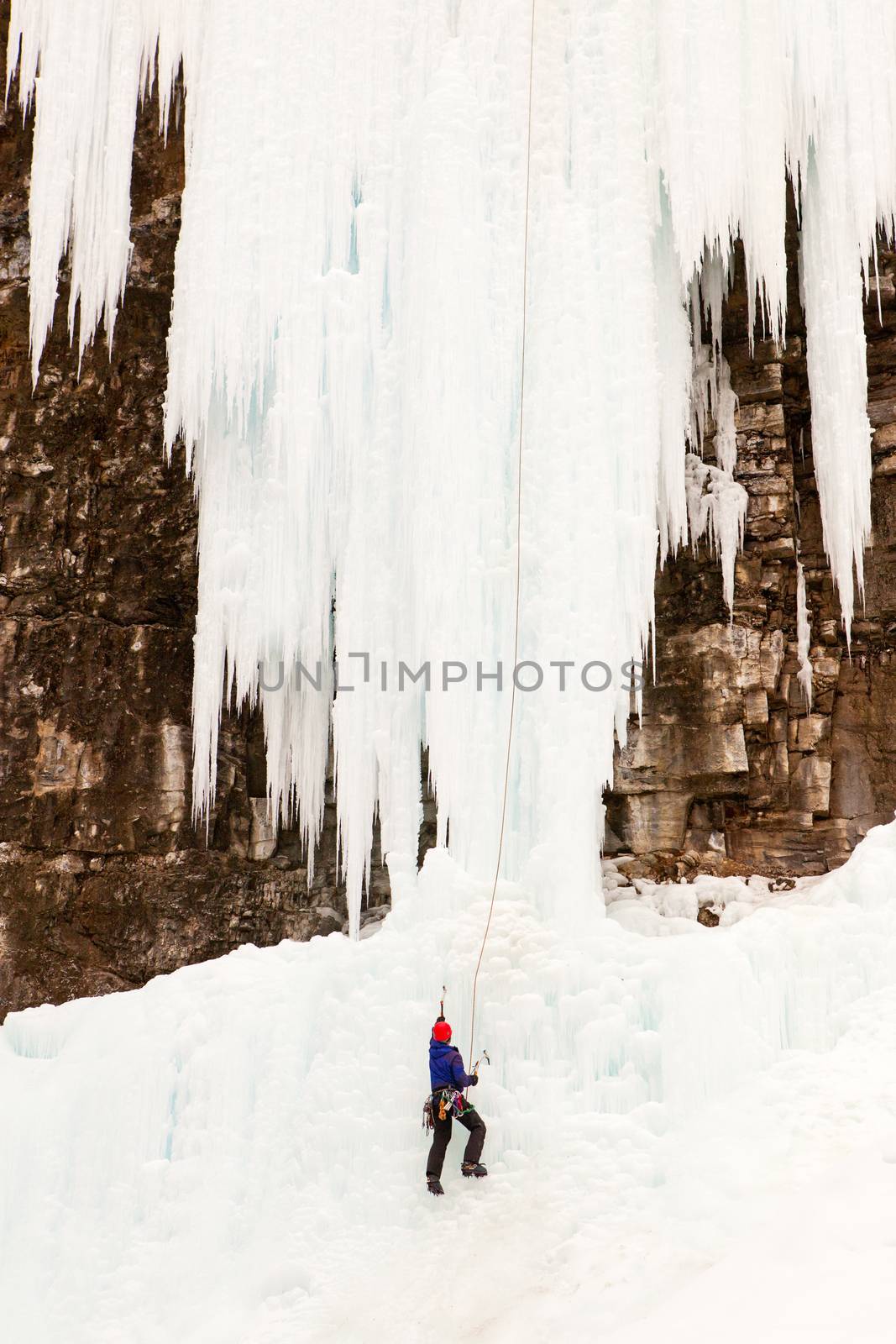 An Ice Climber climbing the Upper Ice Falls in Johnson Canyon.  Located in Banff National Park, Alberta, Canada.