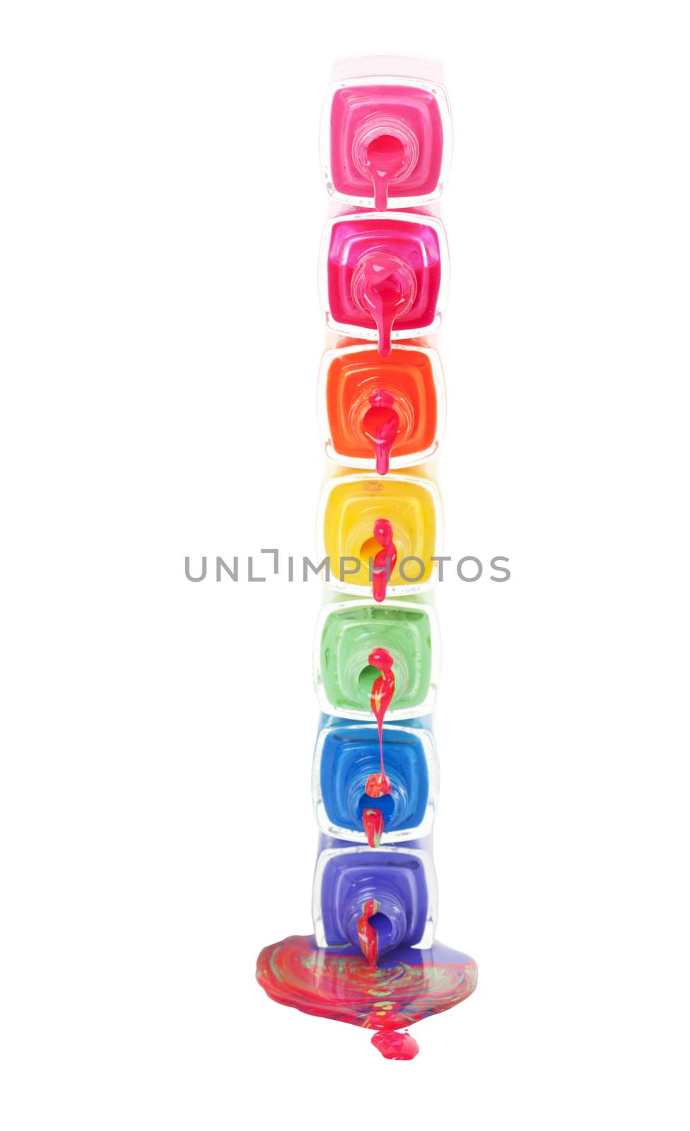 A stack of dripping nail polish in a rainbow of colors.  Shot on white background.