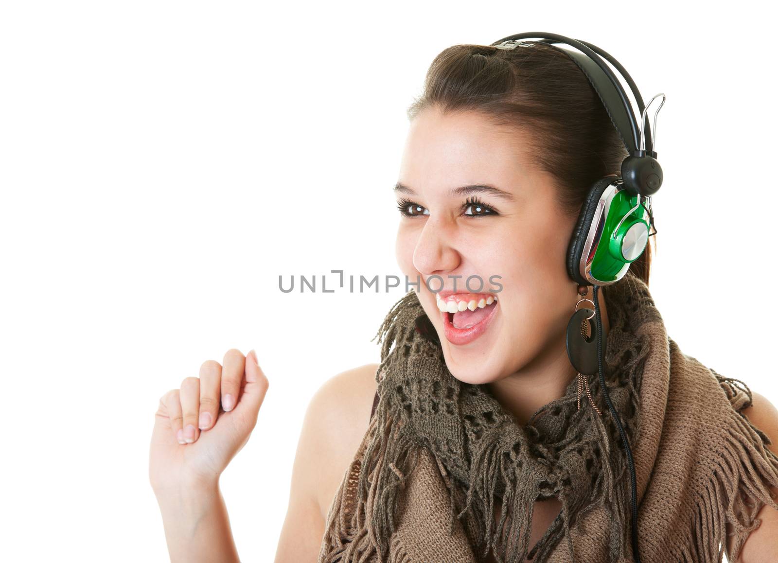 A young woman listening to her favorite tunes through retro styled headphones.  Shot on white background.