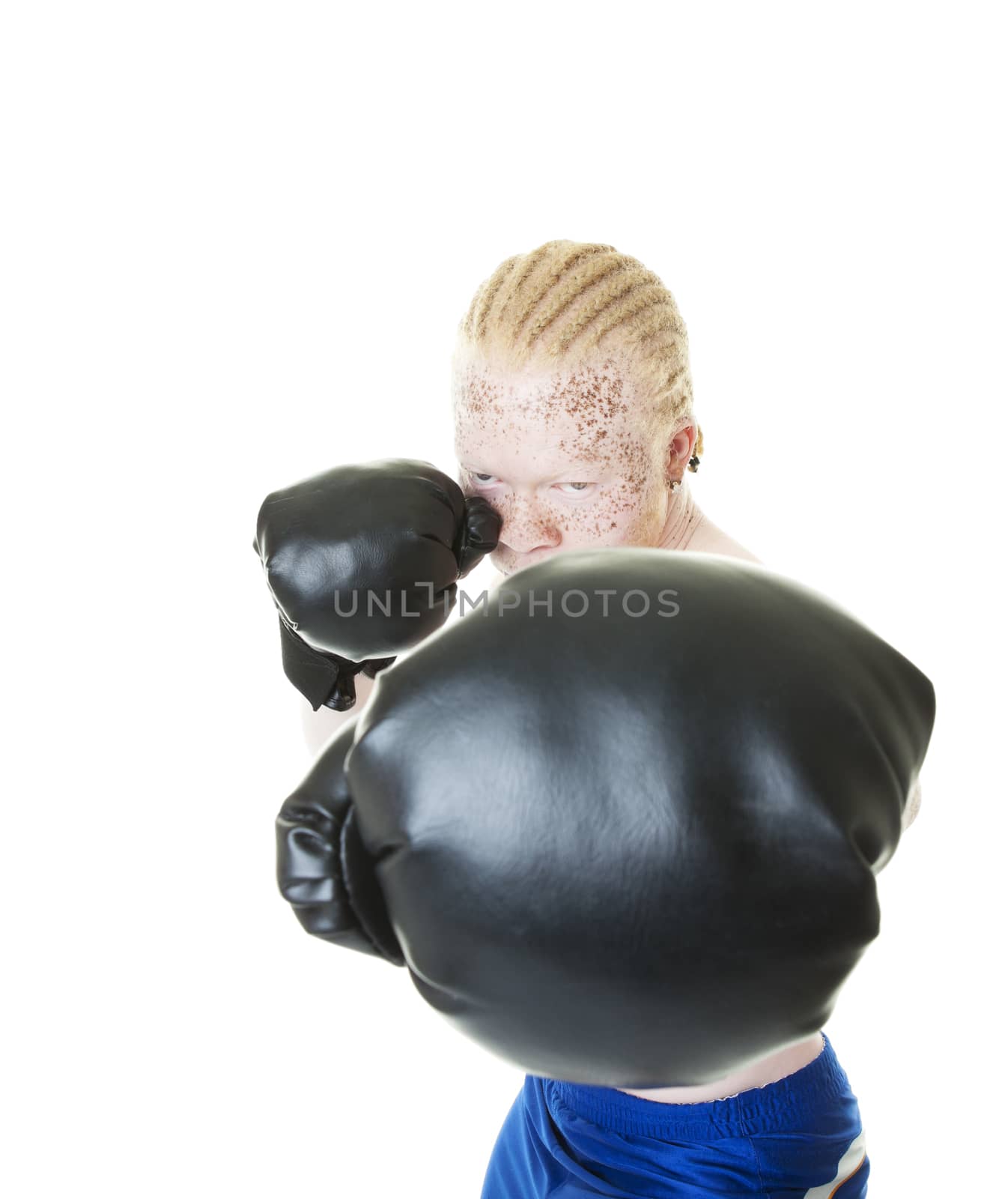 An albino African-American boxer throws a punch towards the camera.