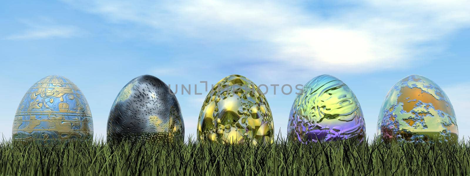Five colorful easter eggs in the grass by beautiful day
