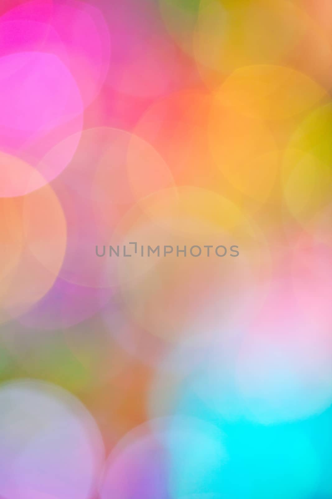 A soft, dreamy bokeh background in a blend of fuchsia, pink, blue, yellow, green, & mauve.