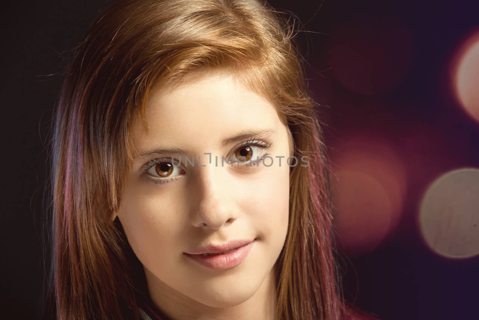 Studio fashion portrait of young beautiful girl with nice eyes on dark red background