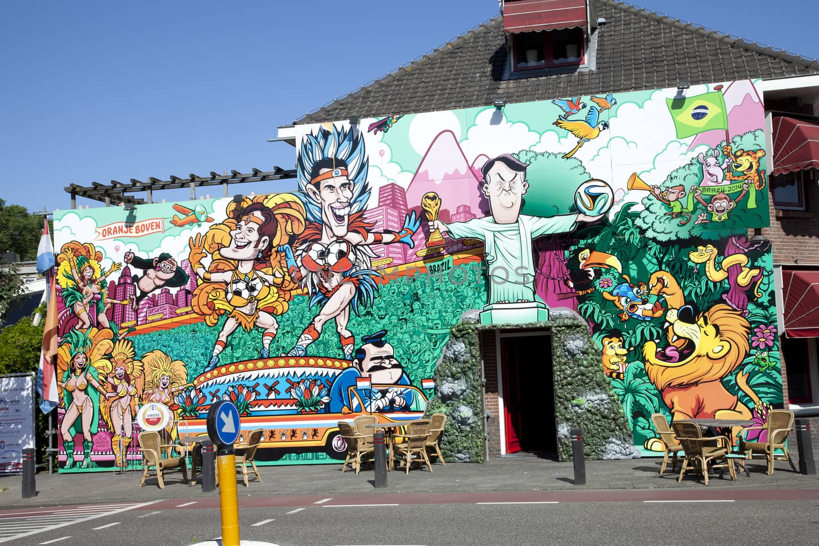 BEVERWIJK, THE NETHERLANDS - JUNE 11, 2014: Colorful street wall painting of Dutch soccer players and coach in Beverwijk, The Netherlands on June 11, 2014. This painting supports the participation of Dutch soccer team at Fifa World Cup Championship 2014 