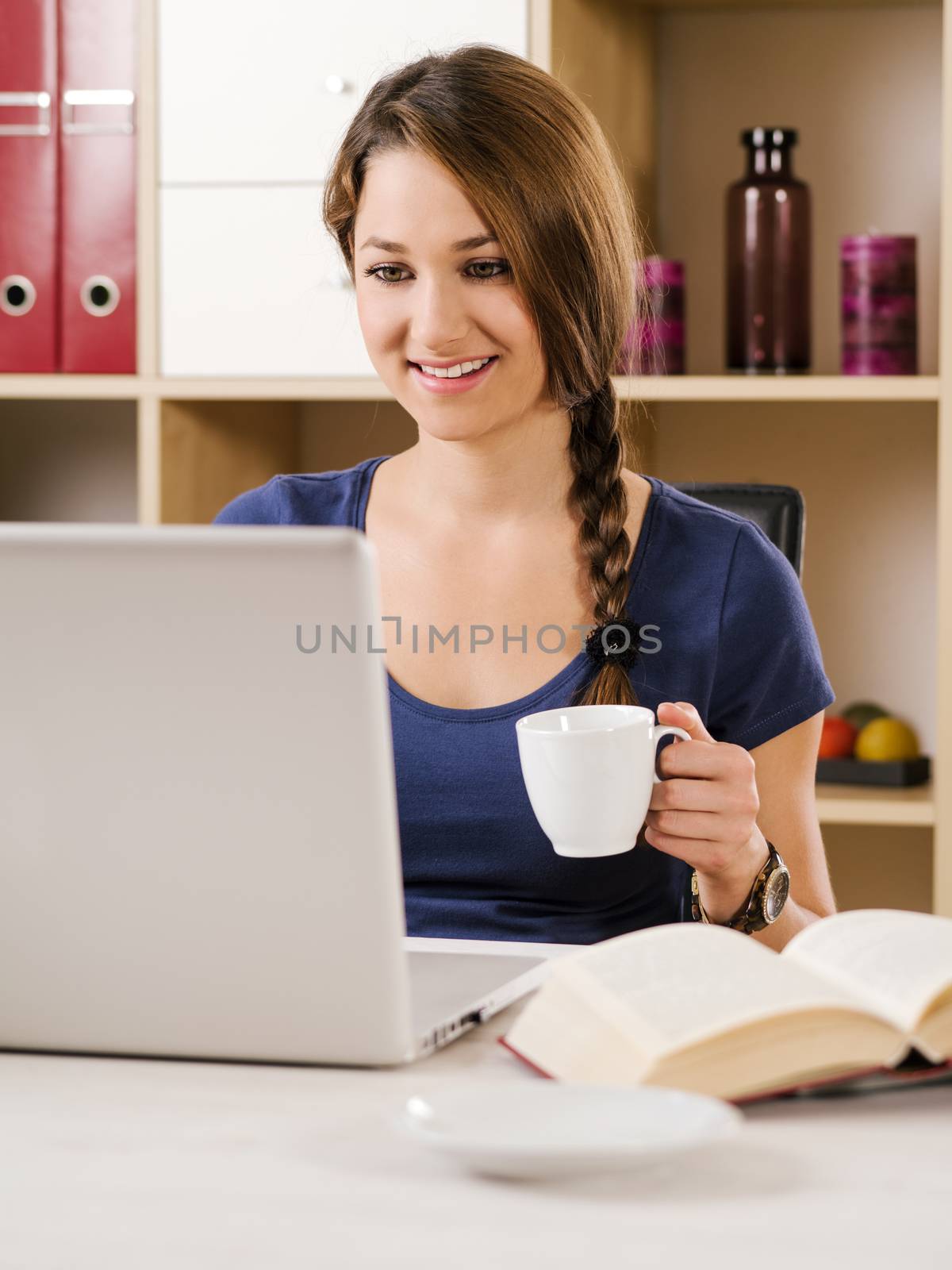 Beautiful woman smiling while using a laptop by sumners