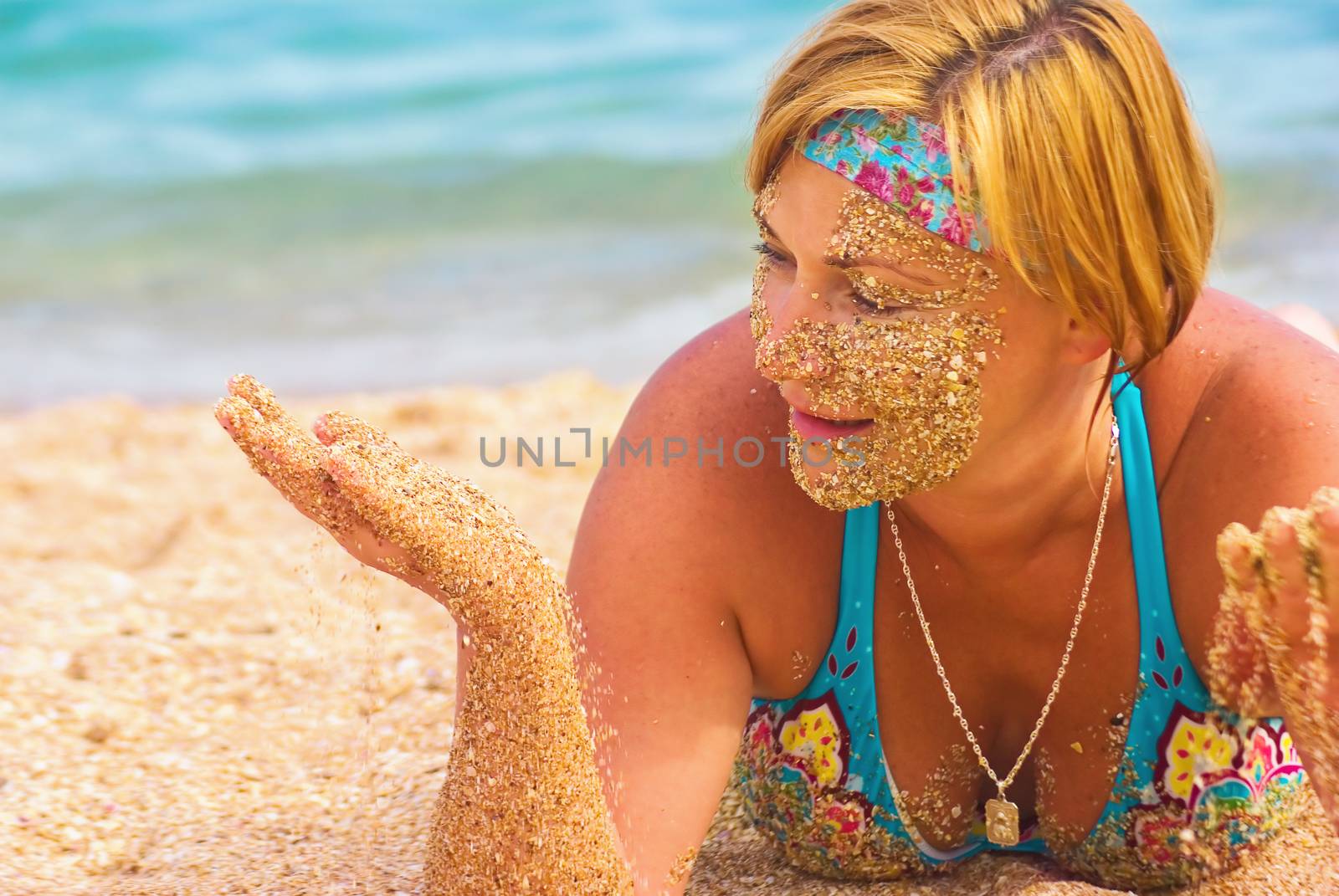 Mature woman lying on a sandy beach