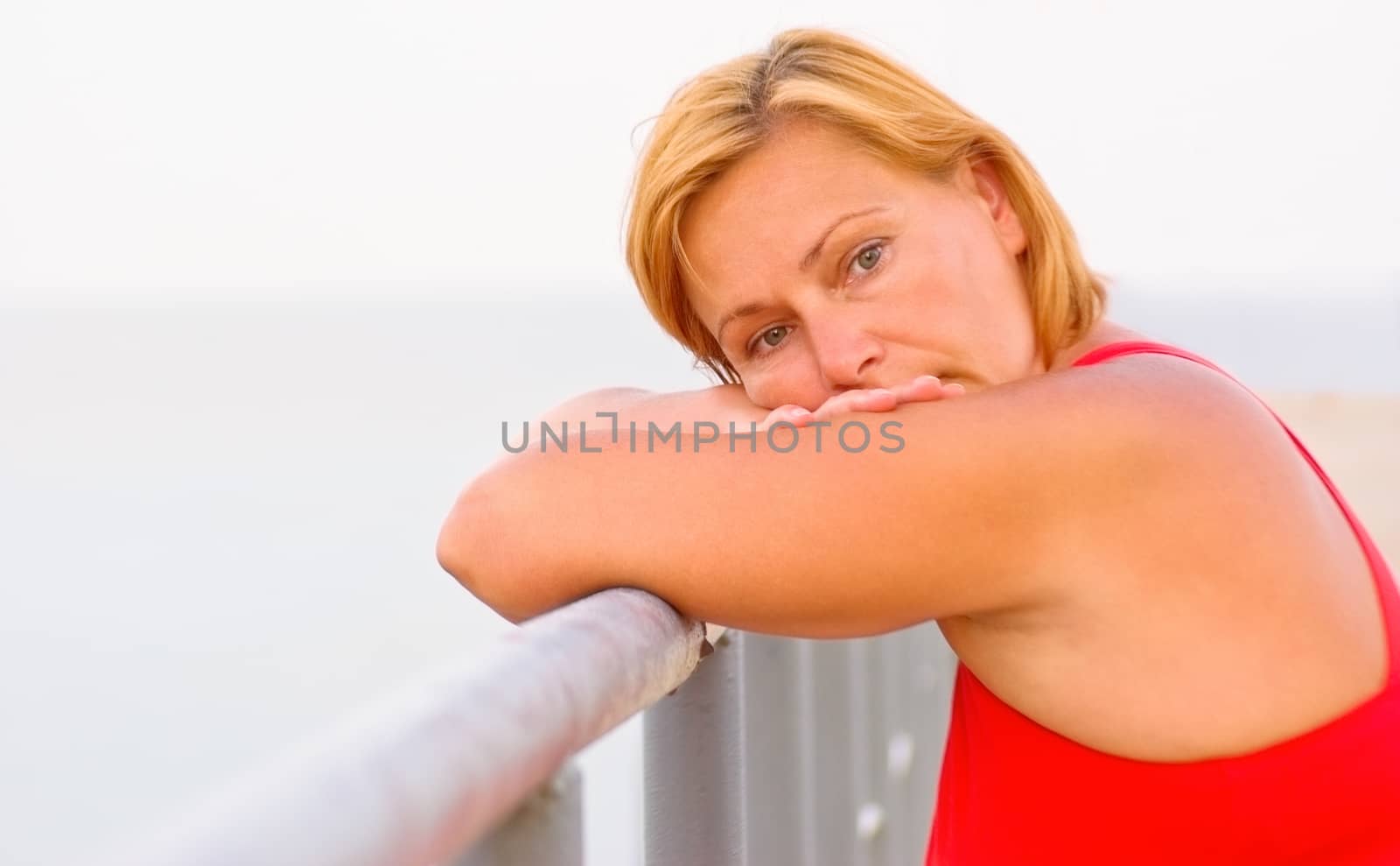 Portrait attractive mature woman with thoughtful, worried and depressed facial expression alone outdoor