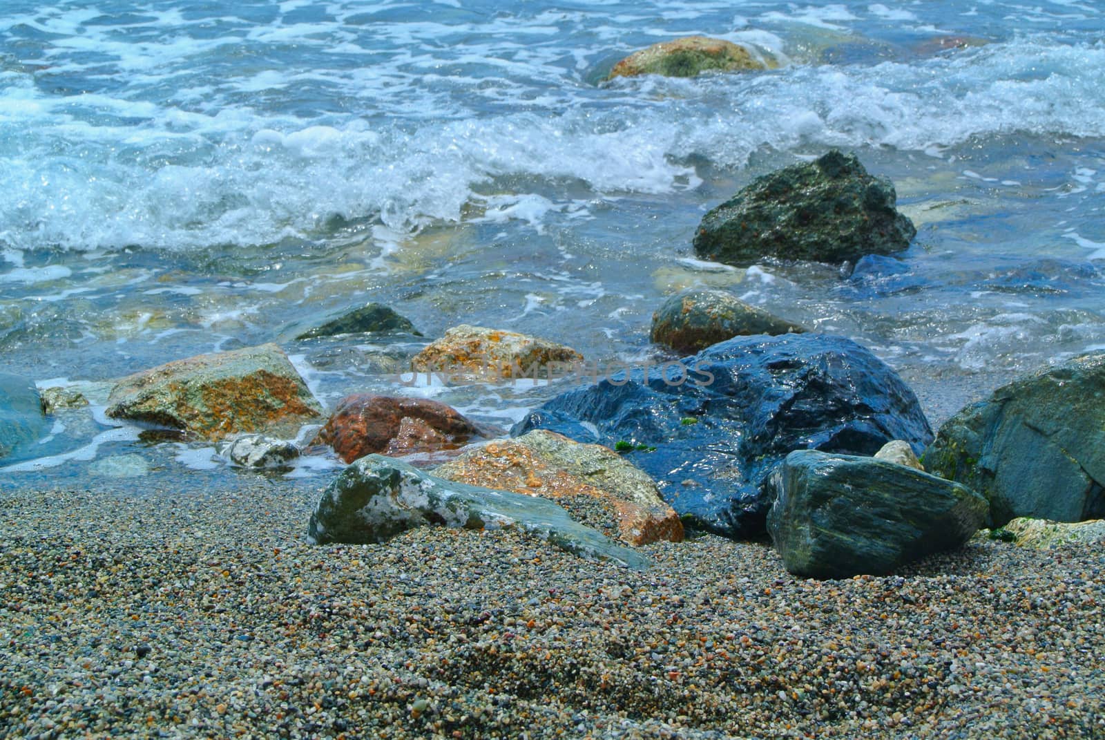 Sea coming to beach, with big rocks