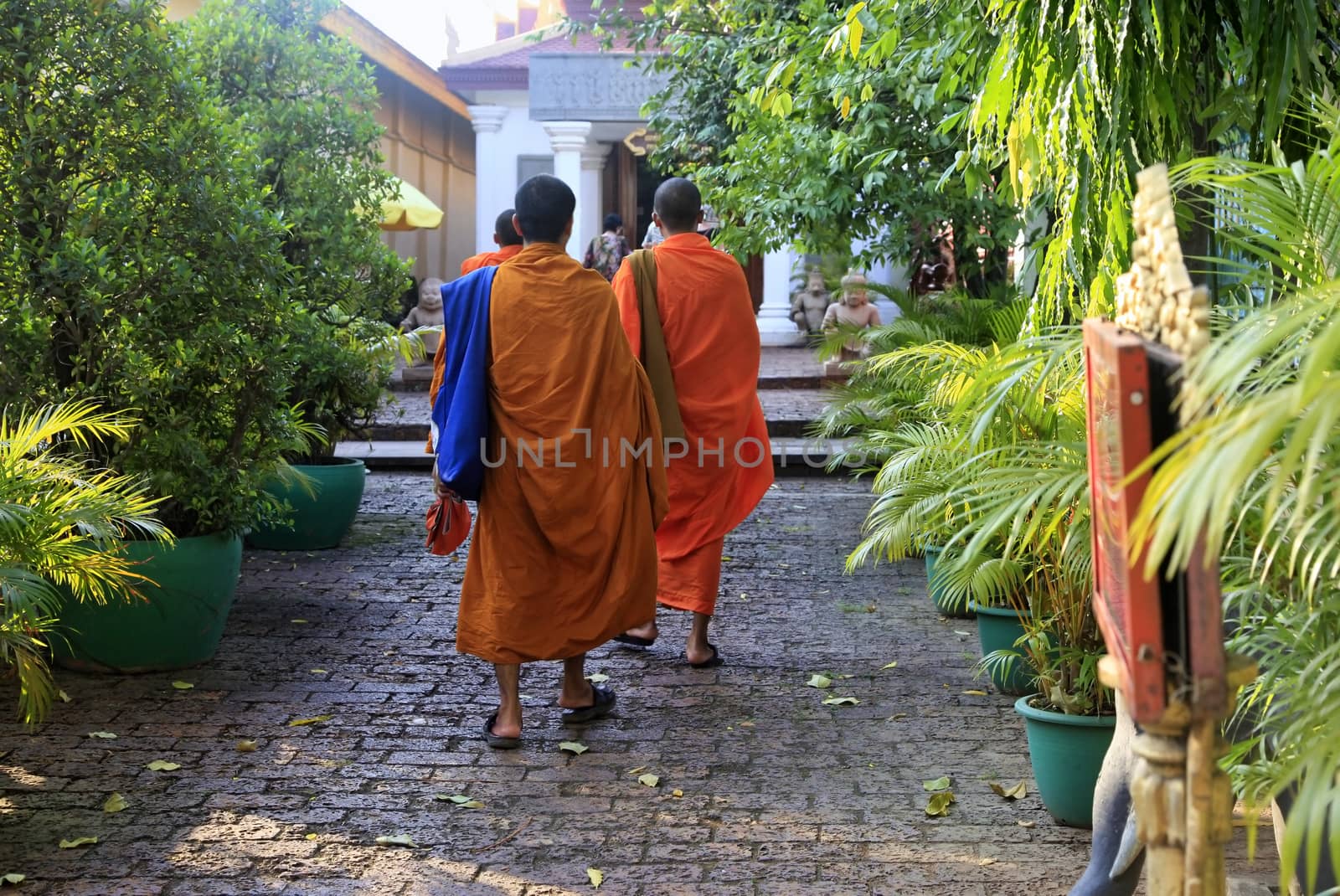 PHNOM PENH, CAMBODIA - APRIL 24: Cambodia monks with orange robes in Royal Palace on 24 April 2014, Phnom Penh. Cambodia