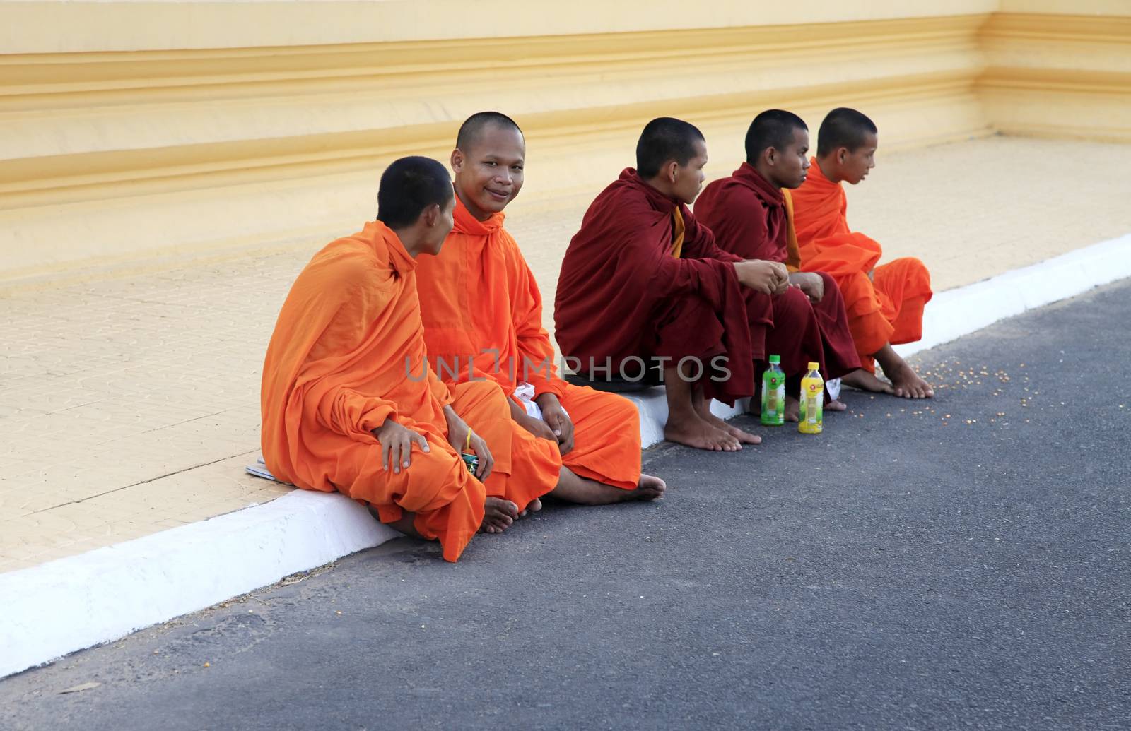PHNOM PENH, CAMBODIA - APRIL 24: Cambodia monks with orange robes in Royal Palace on 24 April 2014, Phnom Penh. Cambodia