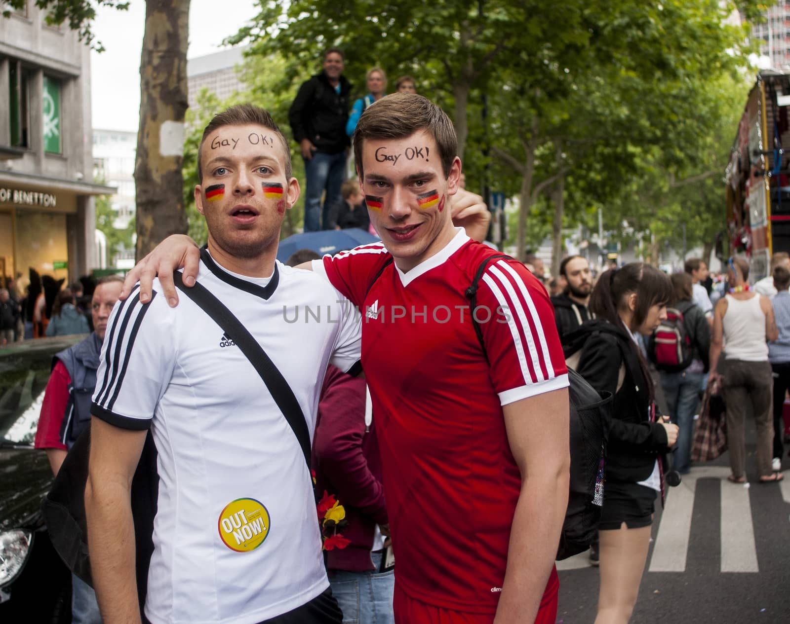 Gay couple dressed as football players. by MarekSzandurski