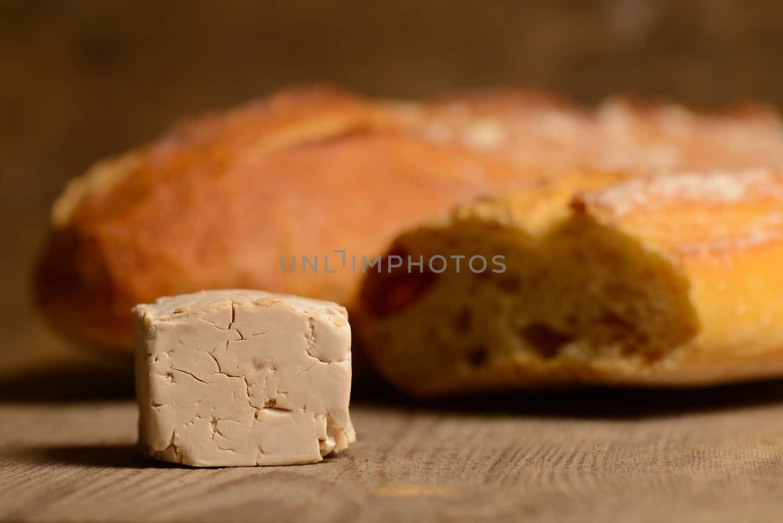 Yeast and bread on wood by FreeProd