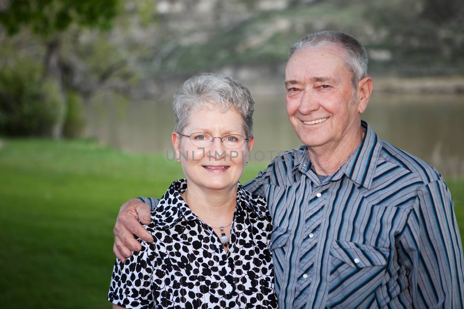 A lovely portrait of  a happy Canadian senior couple outdoors. 