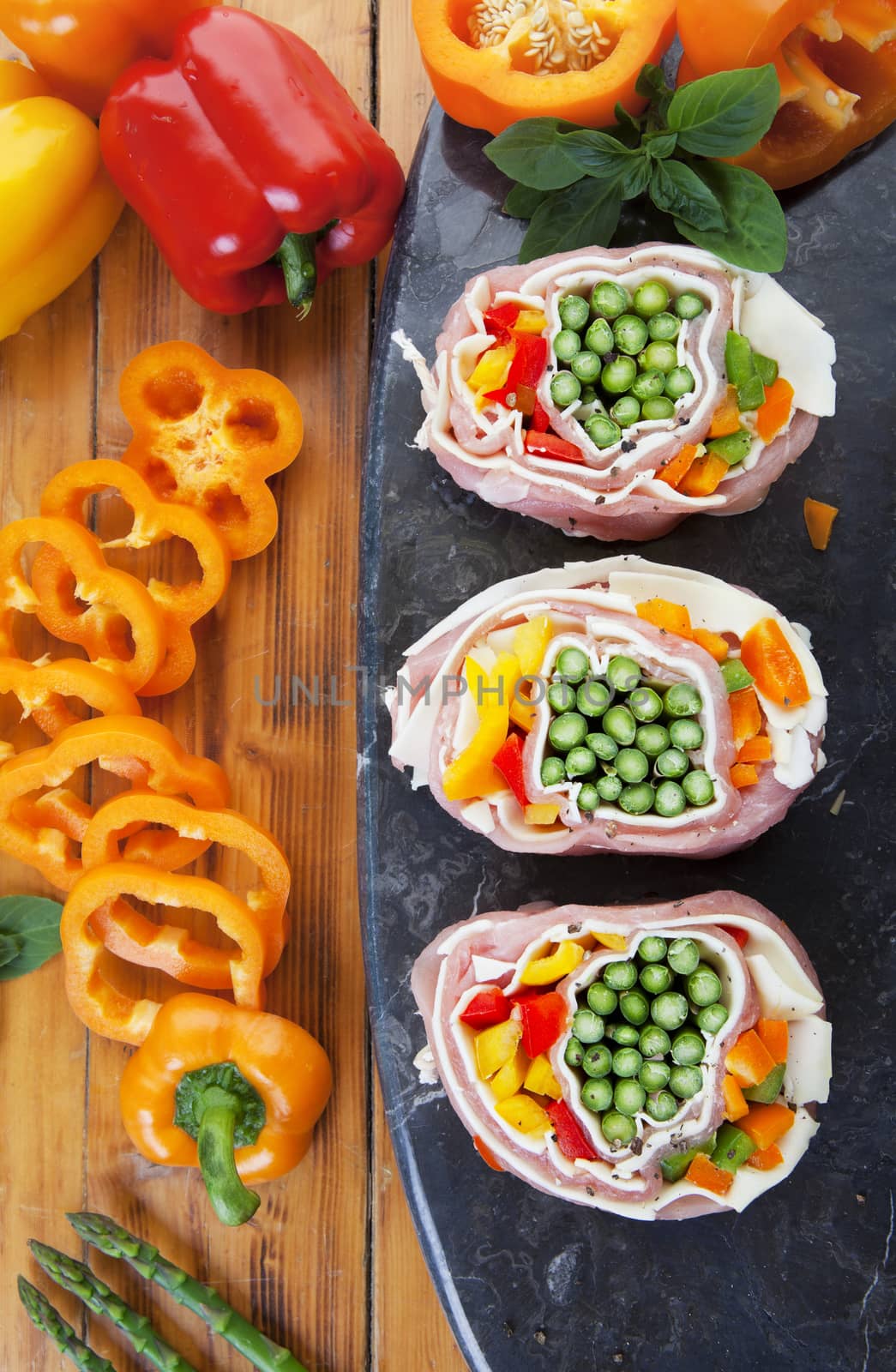 Overhead shot of pork pinwheels stuffed with fresh asparagus, peppers, and mozzarella cheese.