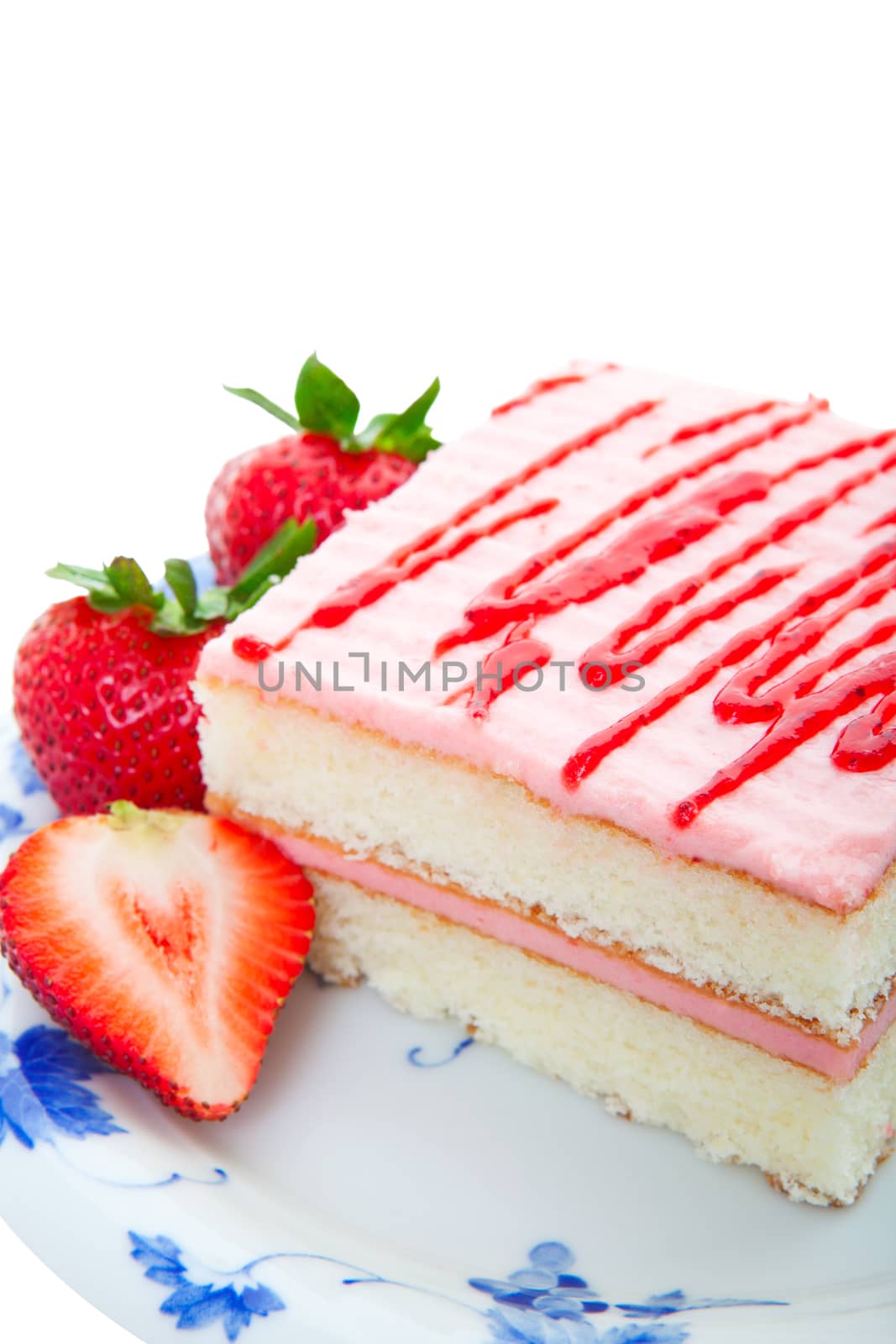 Strawberry layer cake served with fresh strawberries.  Shot on white background.