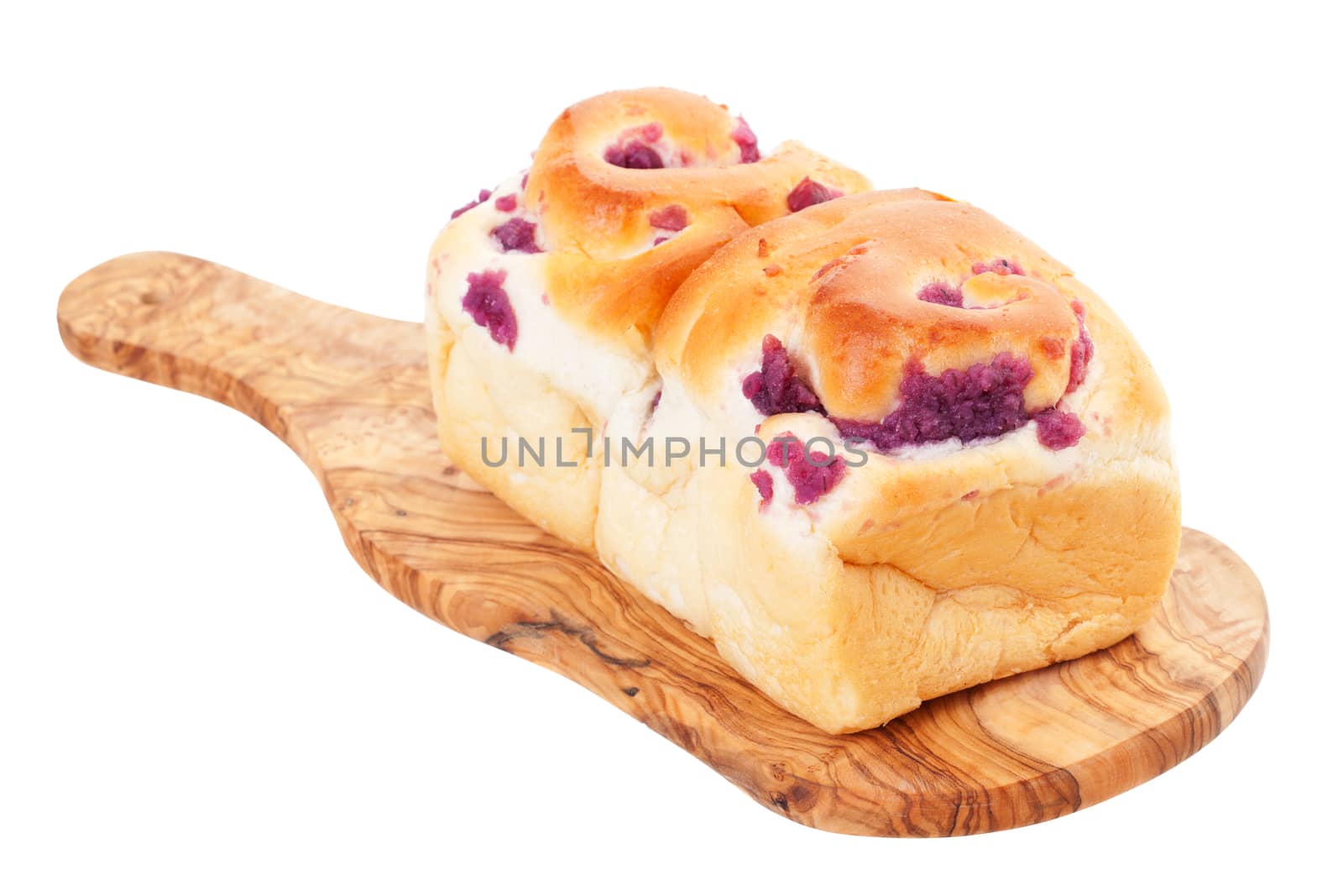 Ube loaf purple yam bread cooling on a wooden board.  An Asian bread.  Shot on white background.