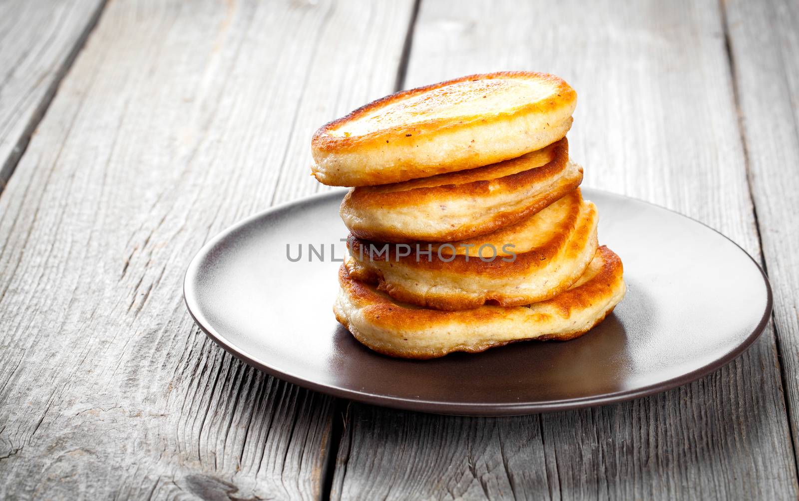 Stack of pancakes on wooden background