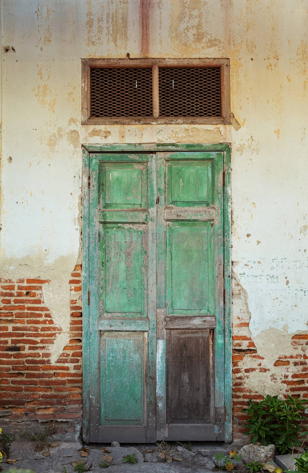 Old wood door on wall of house