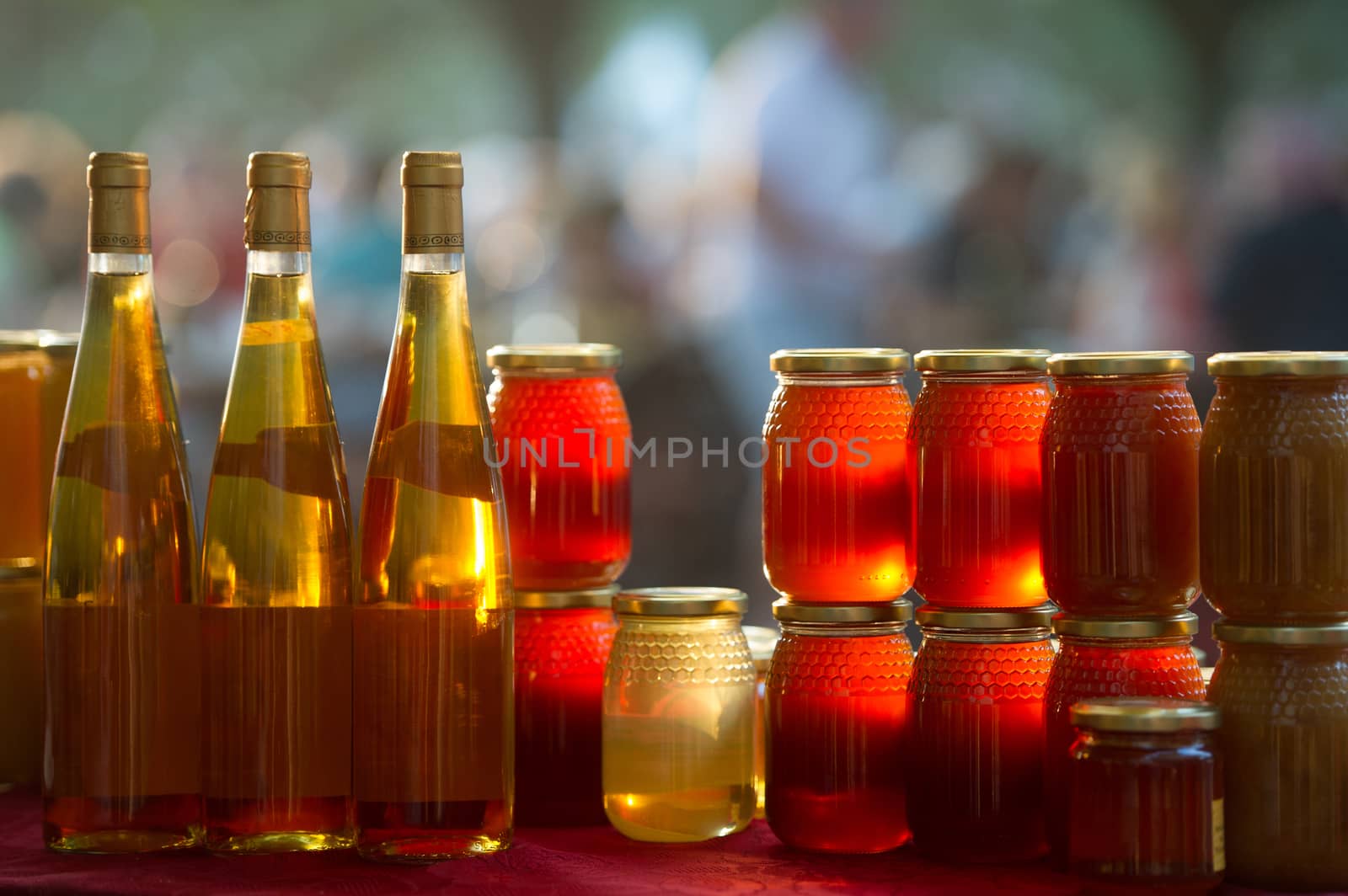 Honey and wine on a market stall by FreeProd