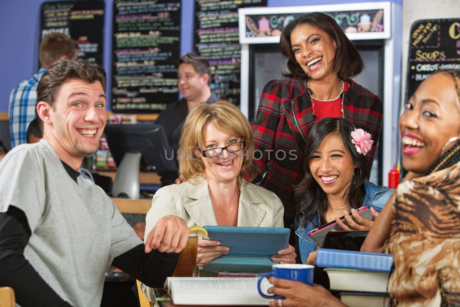 Diverse group of students laughing in coffee house