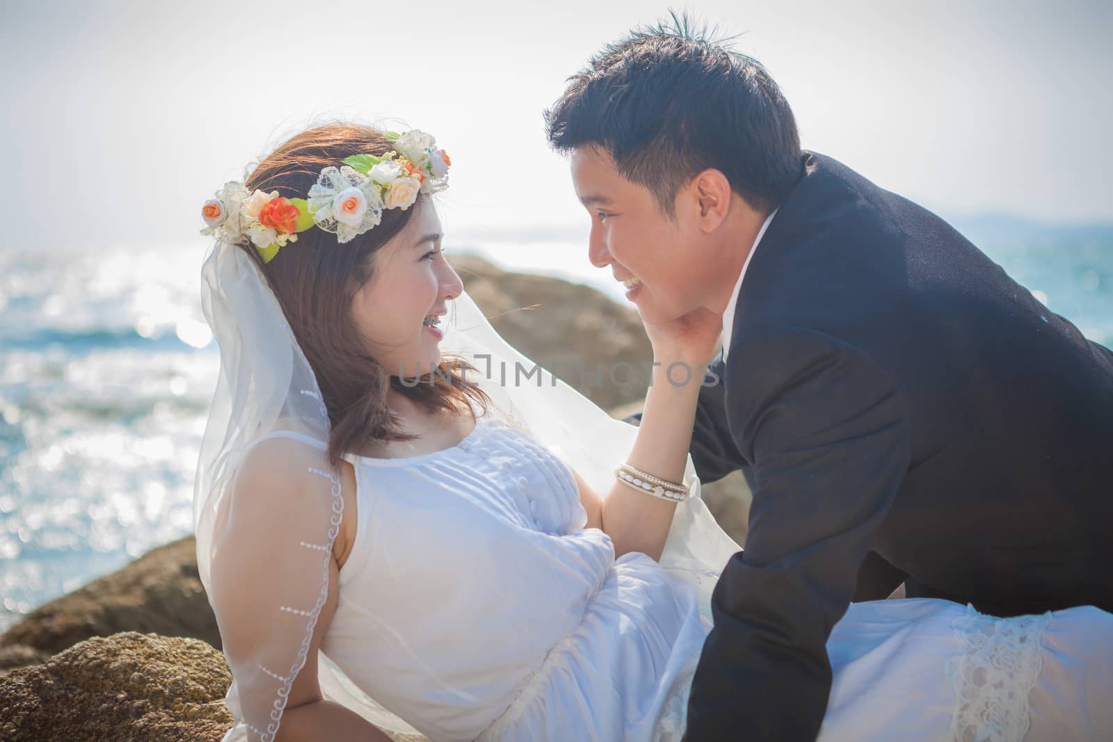 Happy young asian couple in love outdoor on the beach