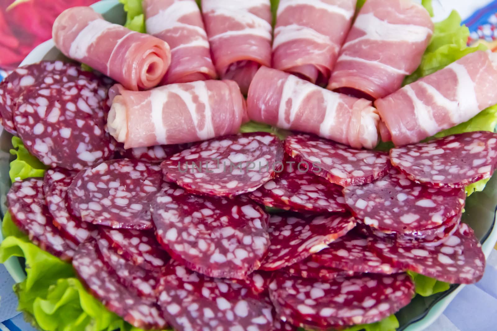 Photo with appetizing sausage and meat on the table