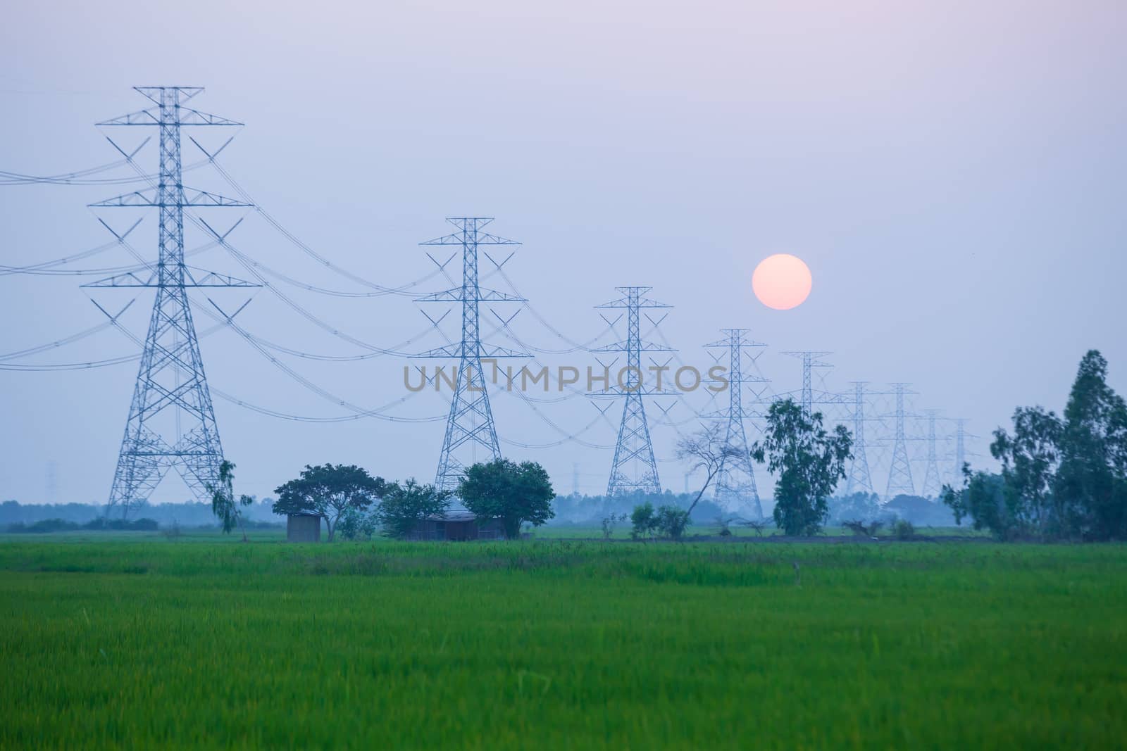 Electric power station in the field on sunset