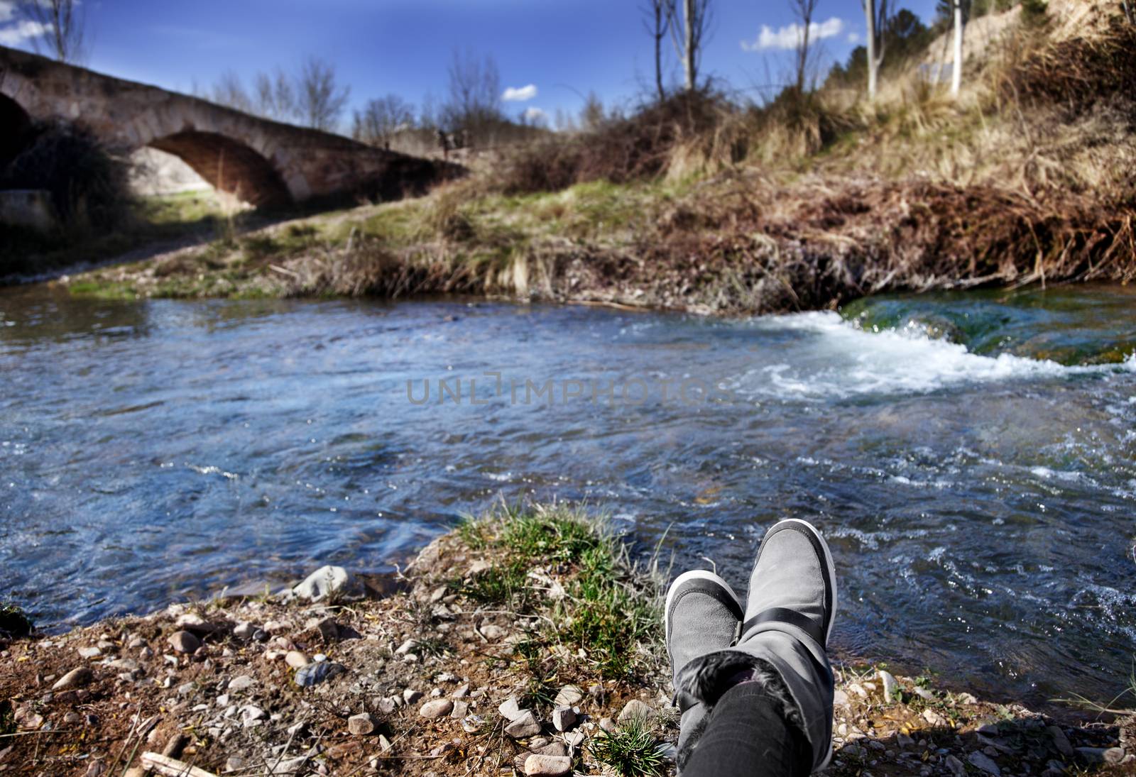 person resting and watching the beautiful scenery of river