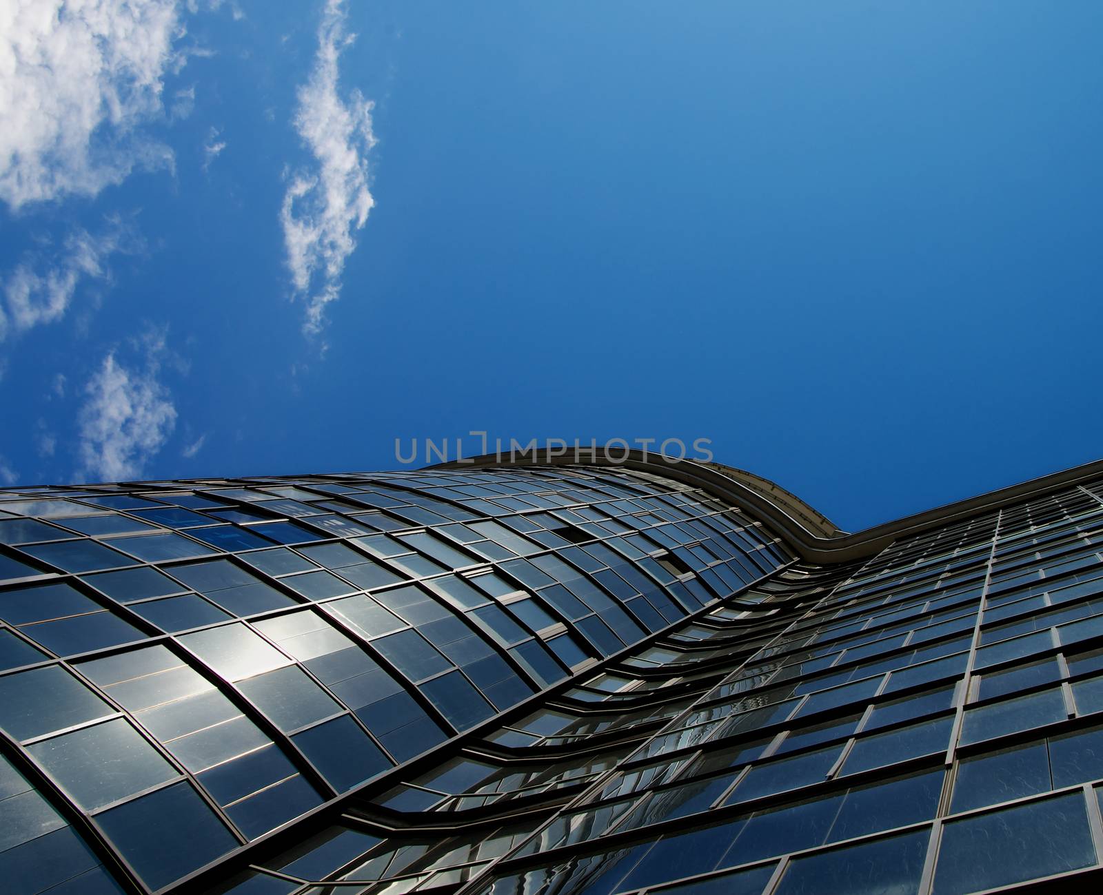 Top of Modern Office Building on Blue Sky Background. Bottom View