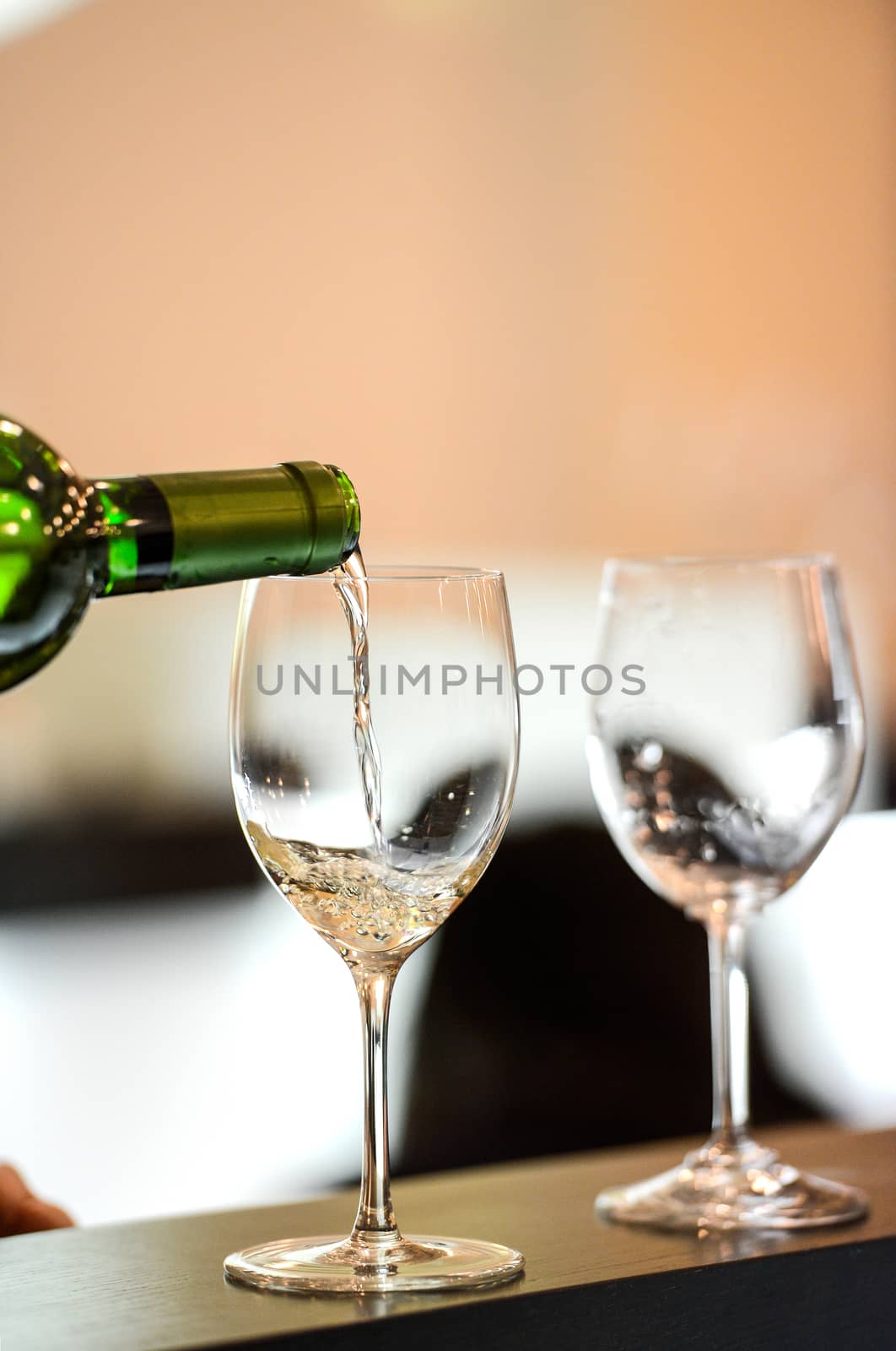 Tasting-White wine pour in a glass