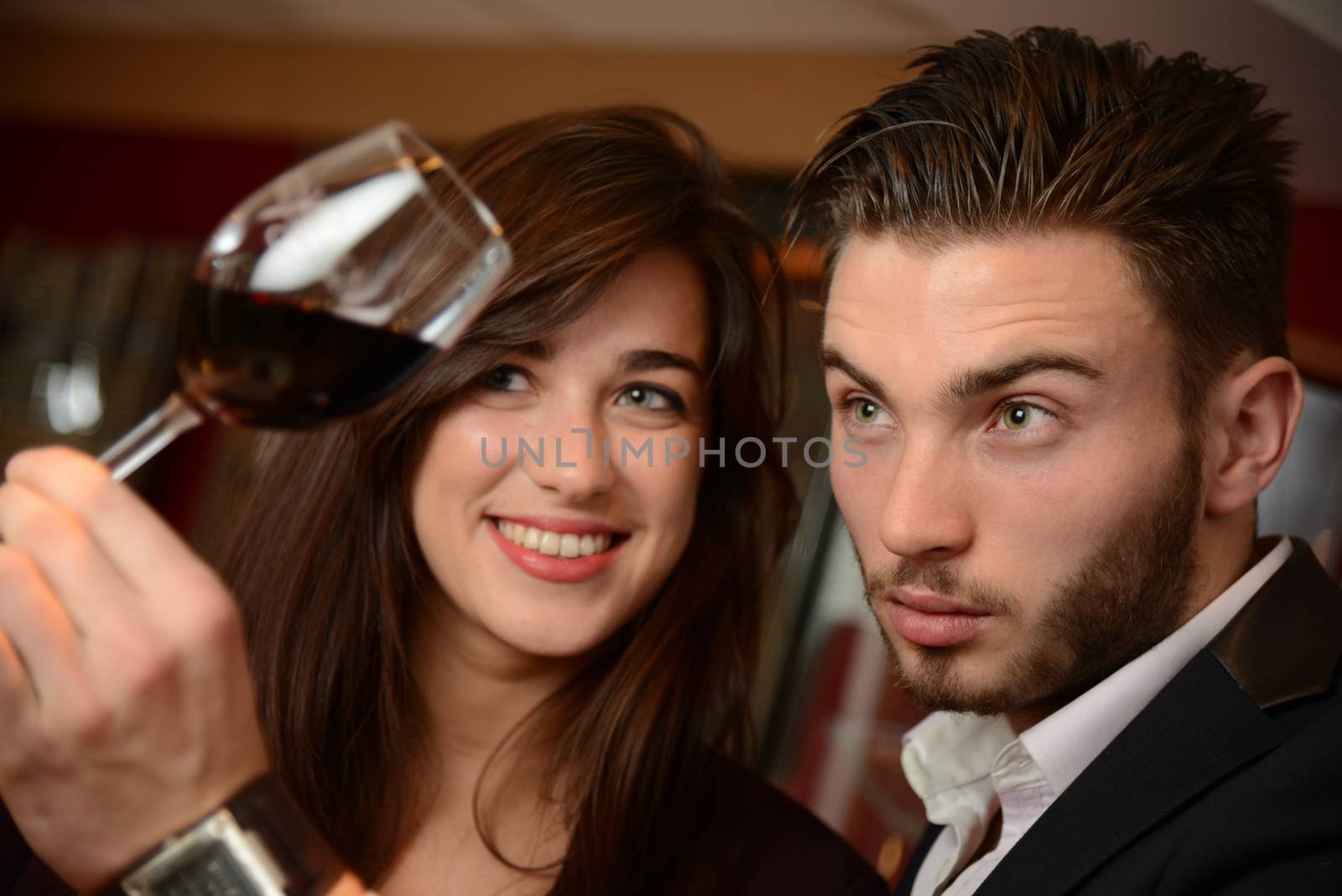 Young couples with redwine glasses at celebration or party