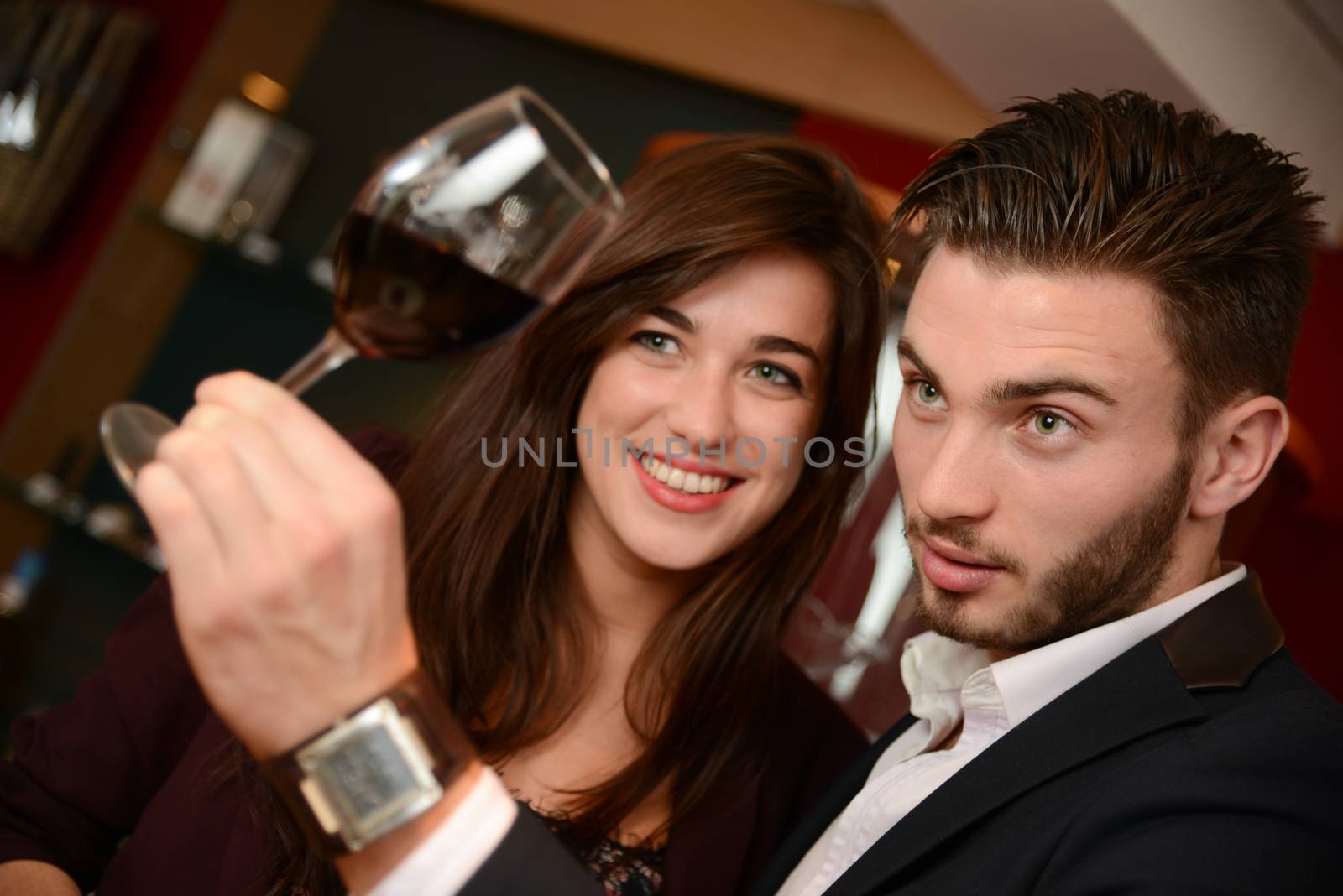 Young couples with redwine glasses at celebration or party
