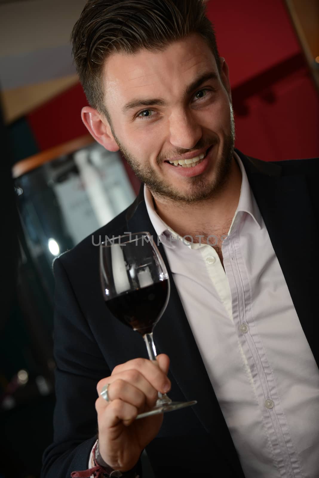 Young man with redwine glasses at celebration or party