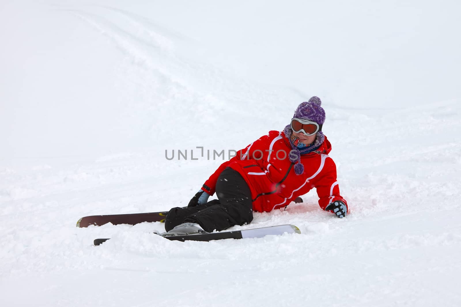 Female skier fallen in deep snow