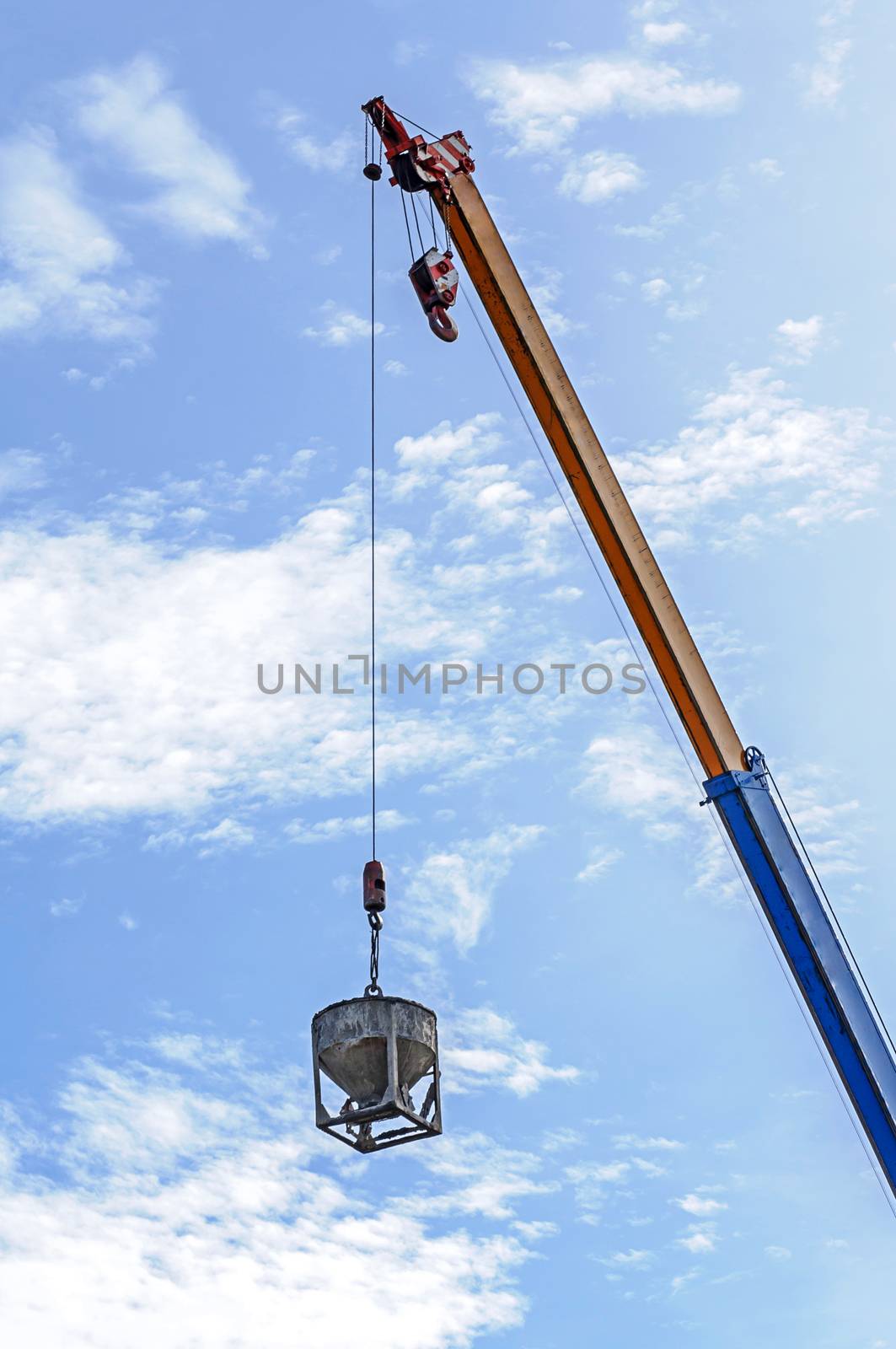 Crane hoist concrete bucket at construction site