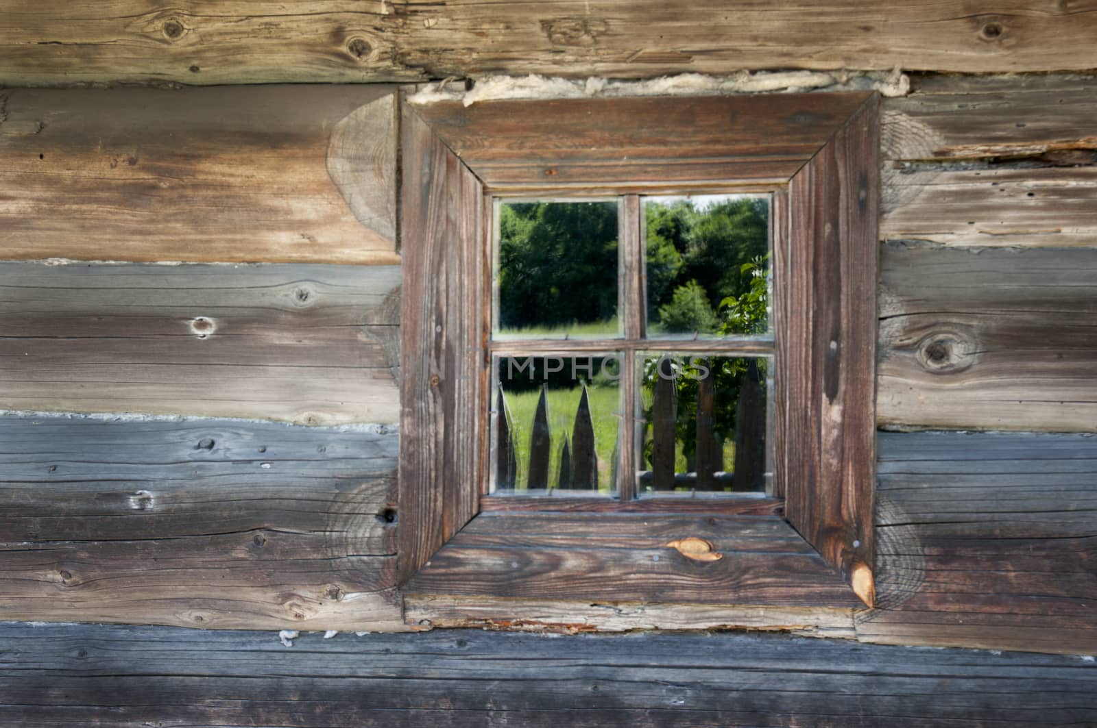 Old window on a wooden farm house wall