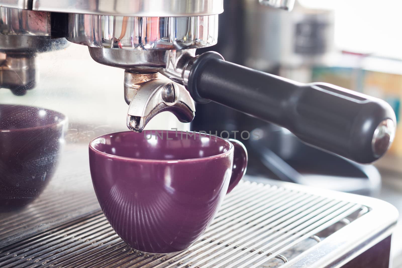 Prepares espresso in coffee shop, stock photo