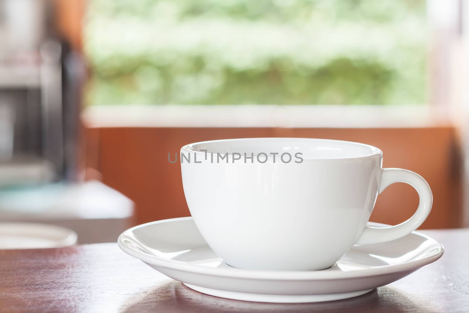 Cup of coffee on wooden counter, stock photo