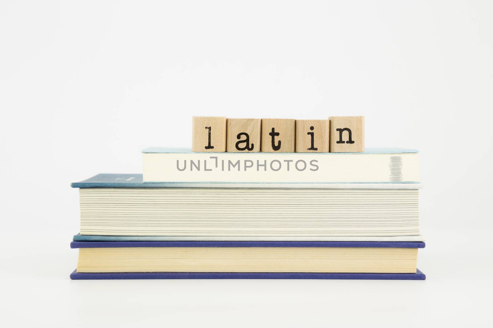 latin language word on wood stamps and books by vinnstock