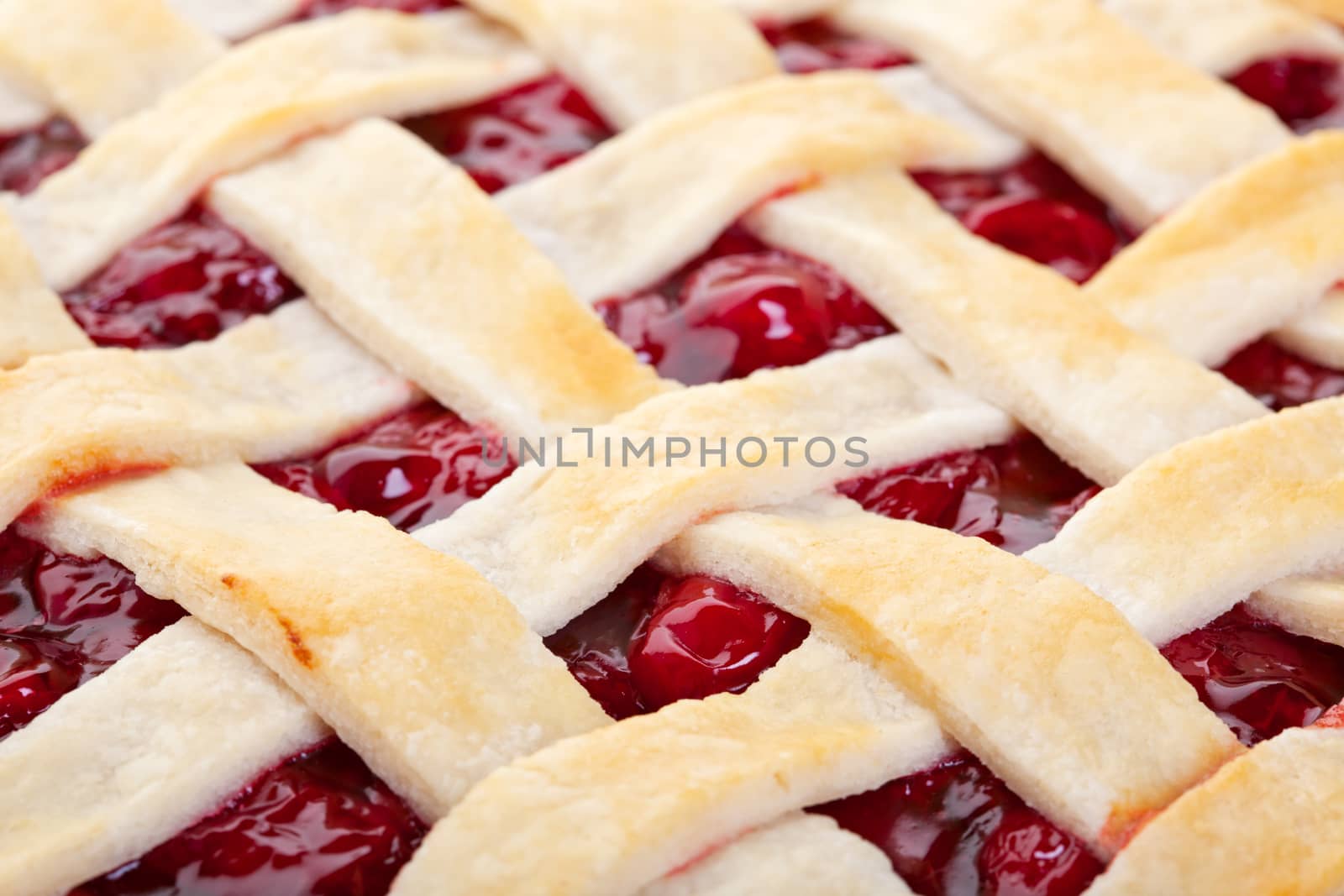 The top of a golden brown cherry pie.  Macro.  Shallow depth of field.