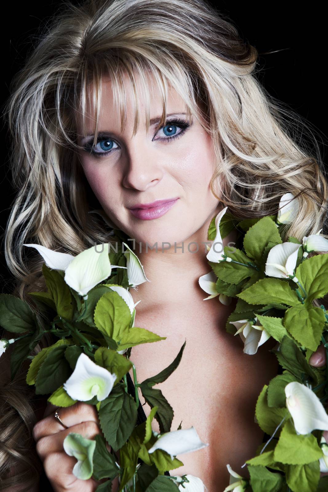 Portrait of a beautiful, blue-eyed blonde woman with silk floral garland around her neck.  